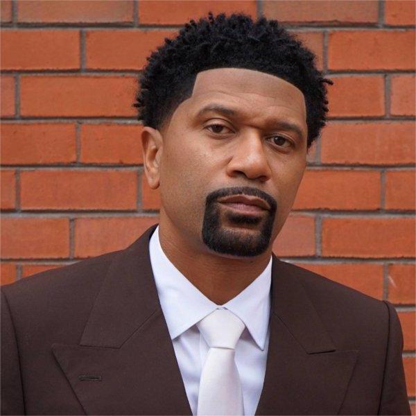 Jalen Rose in a portrait against a brick wall